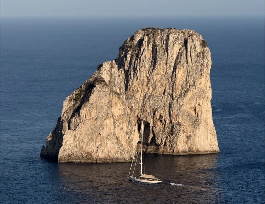 A steep rocky island surrounded by the sea