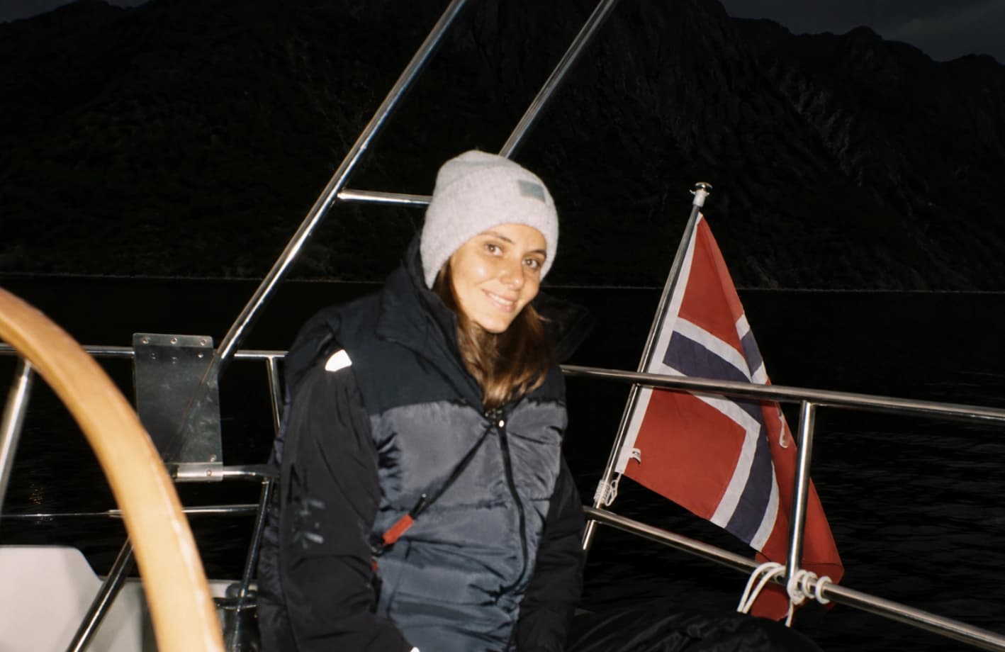 Mariia on board a sailing yacht beside the wheel